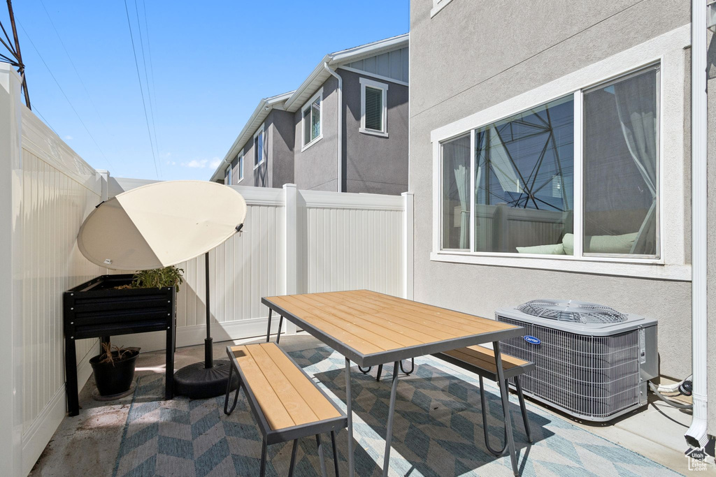 View of patio featuring central AC unit and outdoor dining area