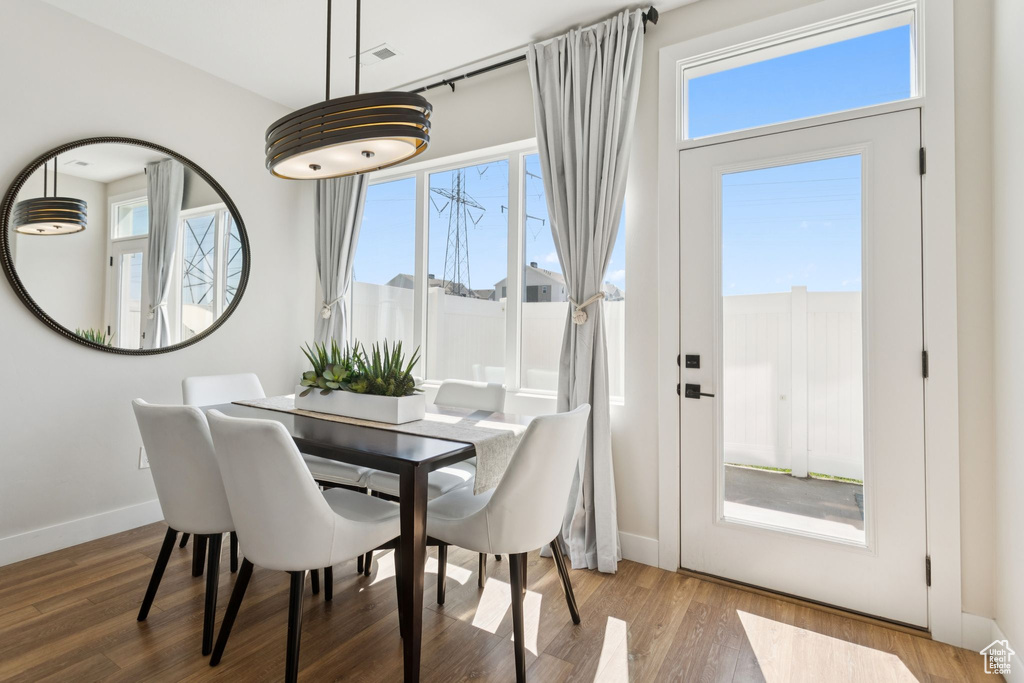 Dining space with wood finished floors and baseboards