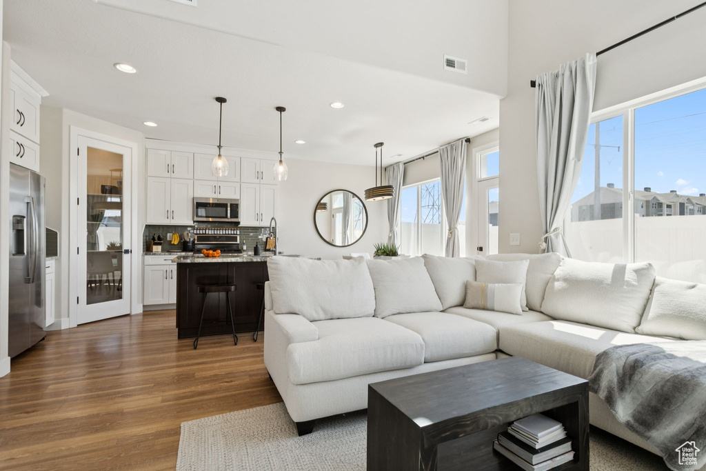 Living area with dark wood finished floors and recessed lighting