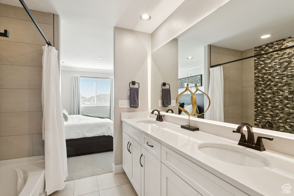 Ensuite bathroom with tile patterned flooring, double vanity, a tile shower, a bathtub, and recessed lighting