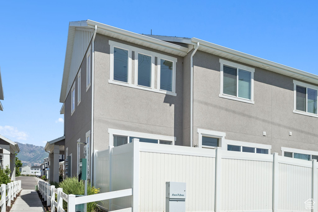 View of front of home with stucco siding and a mountain view