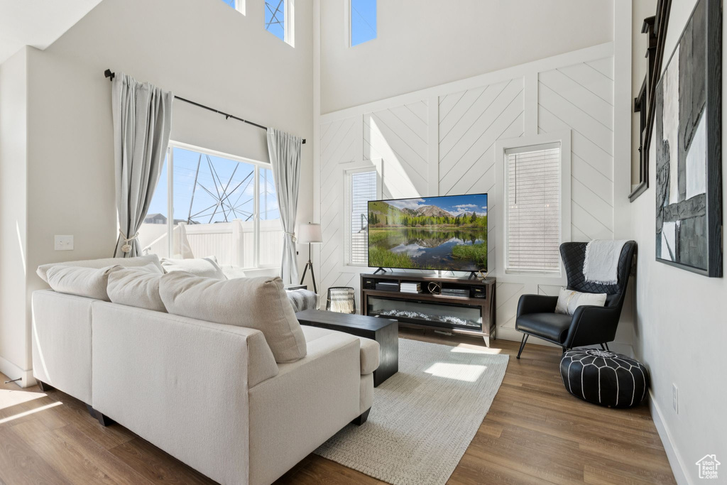 Living room with wood finished floors and a high ceiling