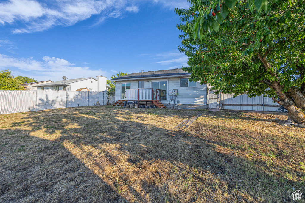 Rear view of property featuring a wooden deck