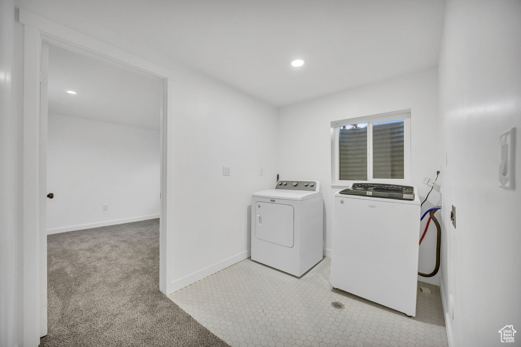 Laundry area with washing machine and clothes dryer, baseboards, recessed lighting, and light colored carpet
