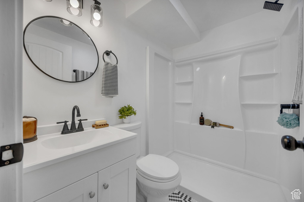 Full bath with vanity, a shower, and toilet