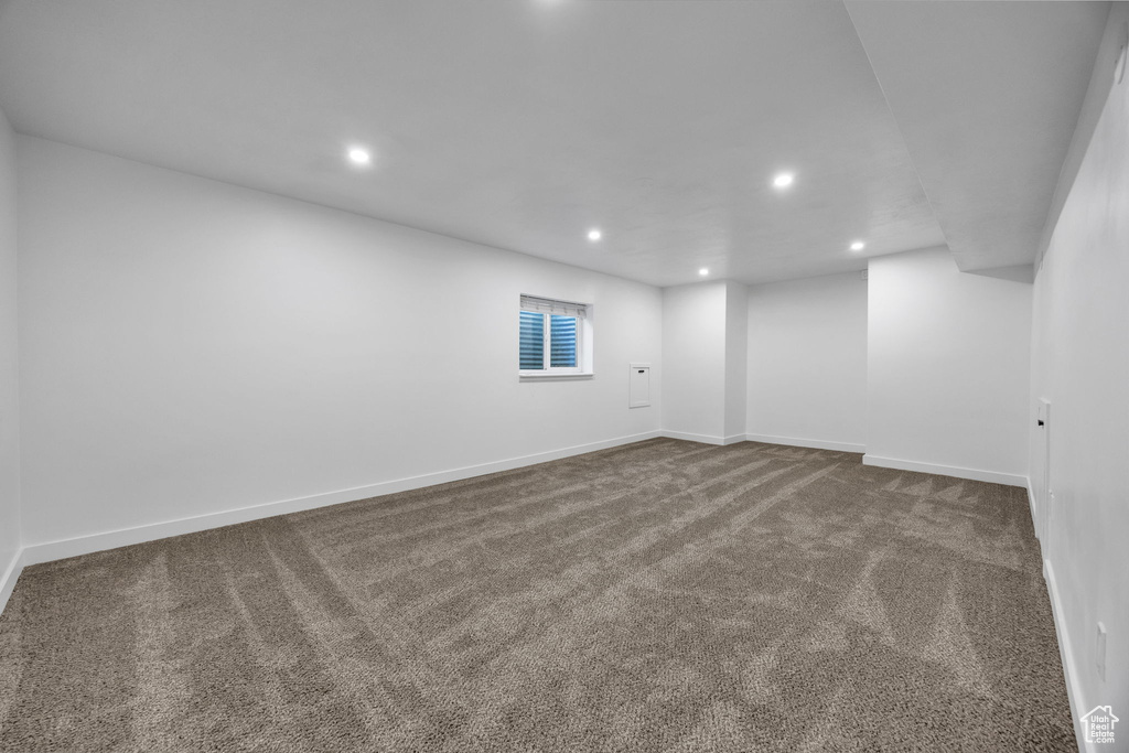Carpeted empty room with recessed lighting and baseboards