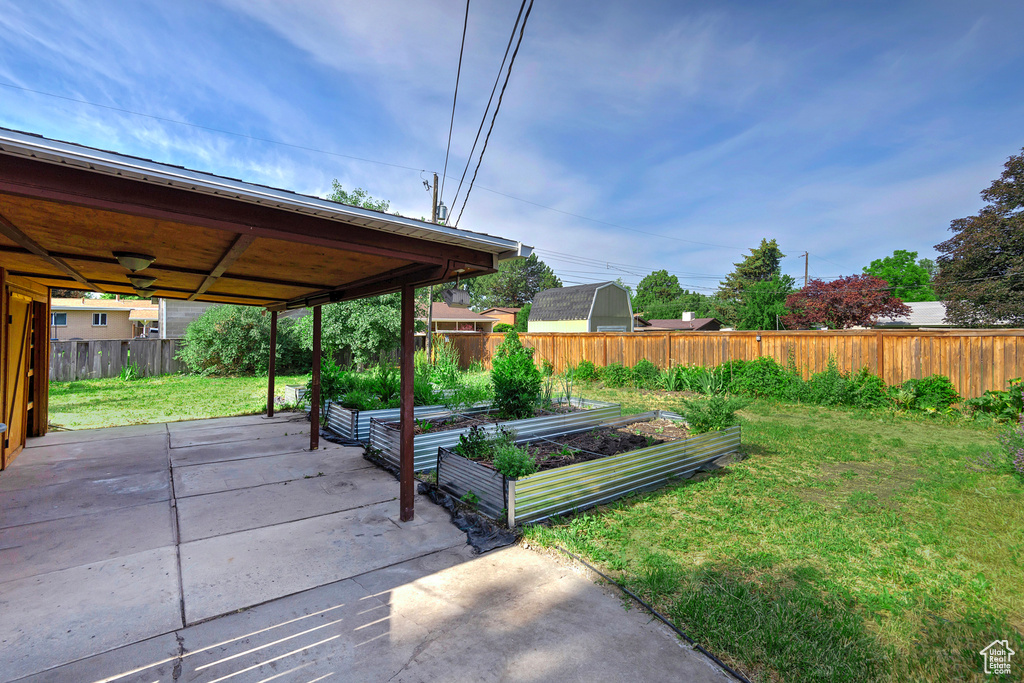 View of yard with a garden and a patio