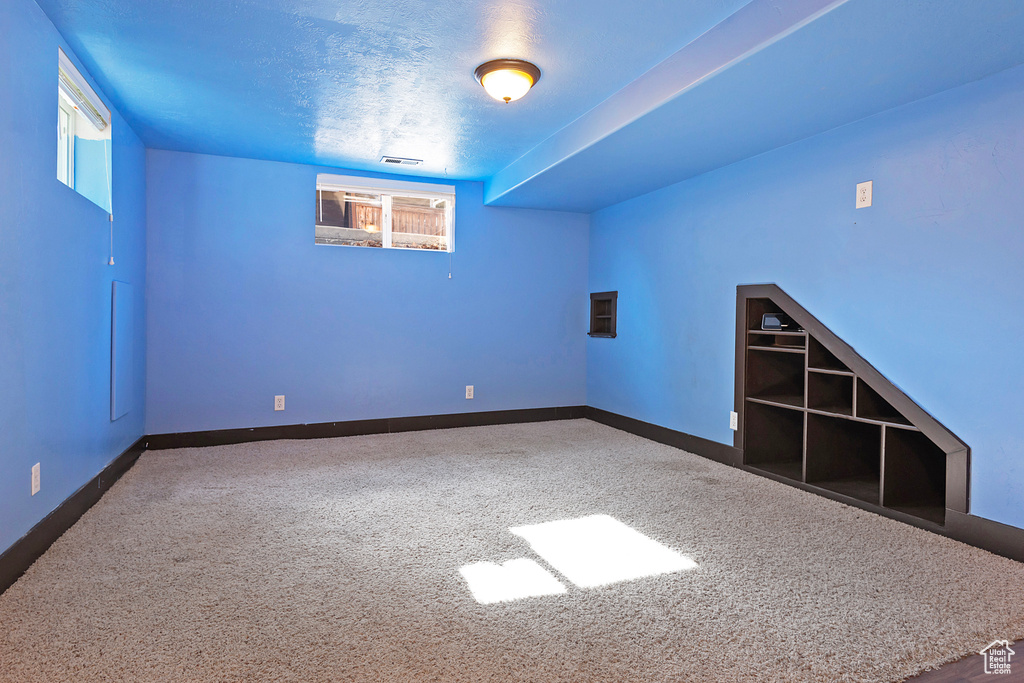 Carpeted empty room with baseboards