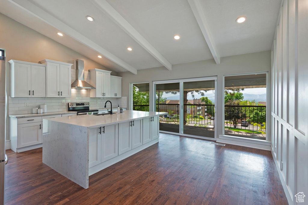 Kitchen featuring wall chimney exhaust hood, electric range, light countertops, dark wood-style floors, and tasteful backsplash