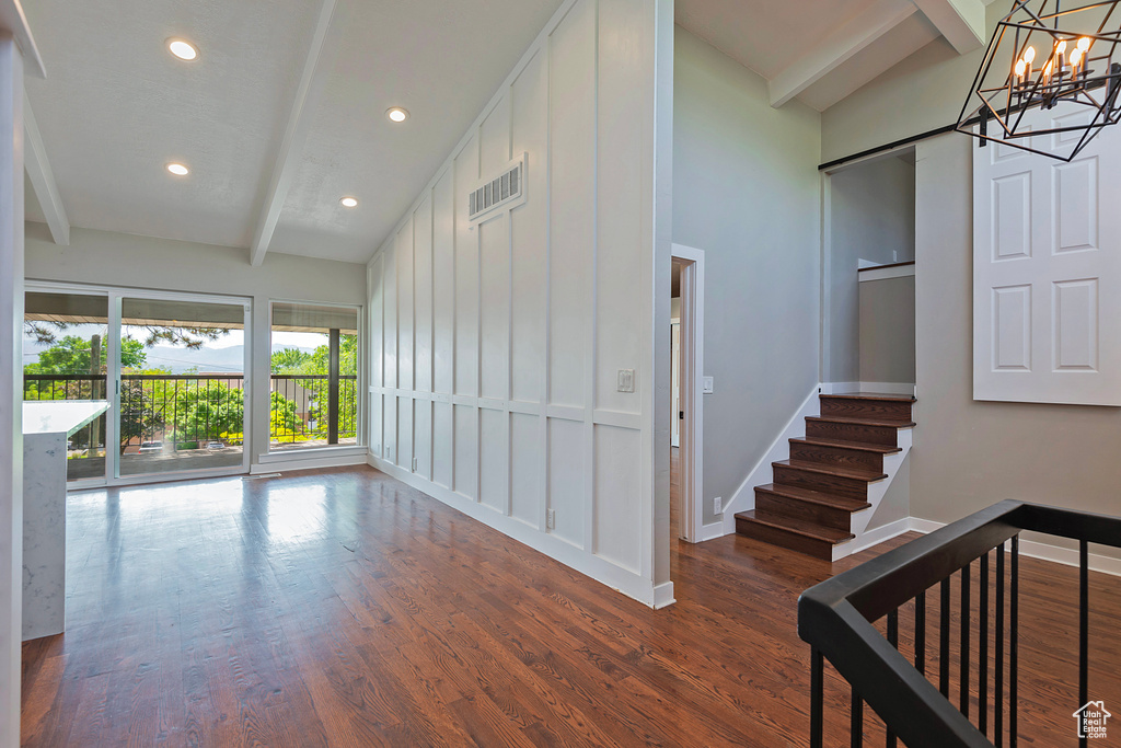 Stairs featuring beamed ceiling, baseboards, recessed lighting, wood finished floors, and a barn door