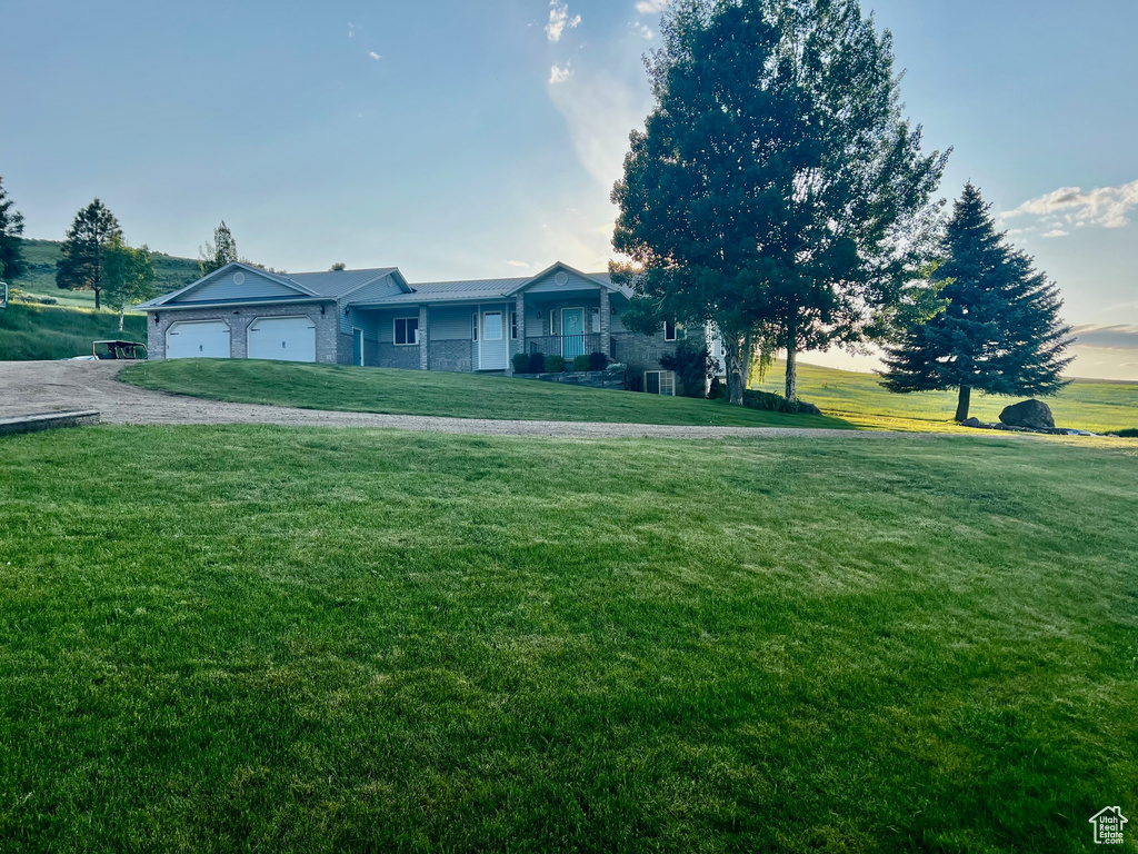 View of front of house with a garage and a front lawn