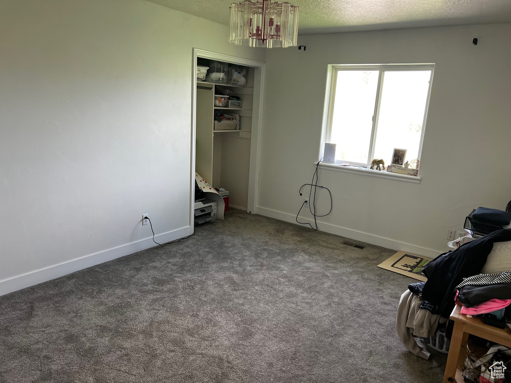 Interior space with carpet flooring and baseboards