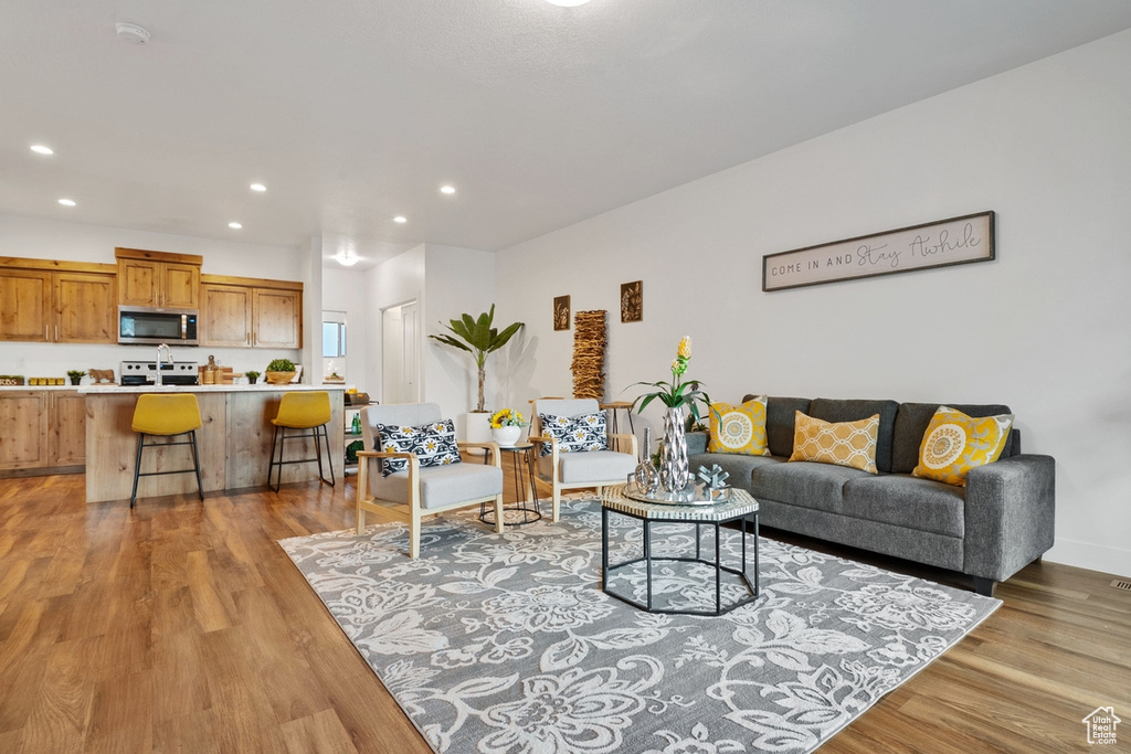 Living area featuring light wood-type flooring and recessed lighting