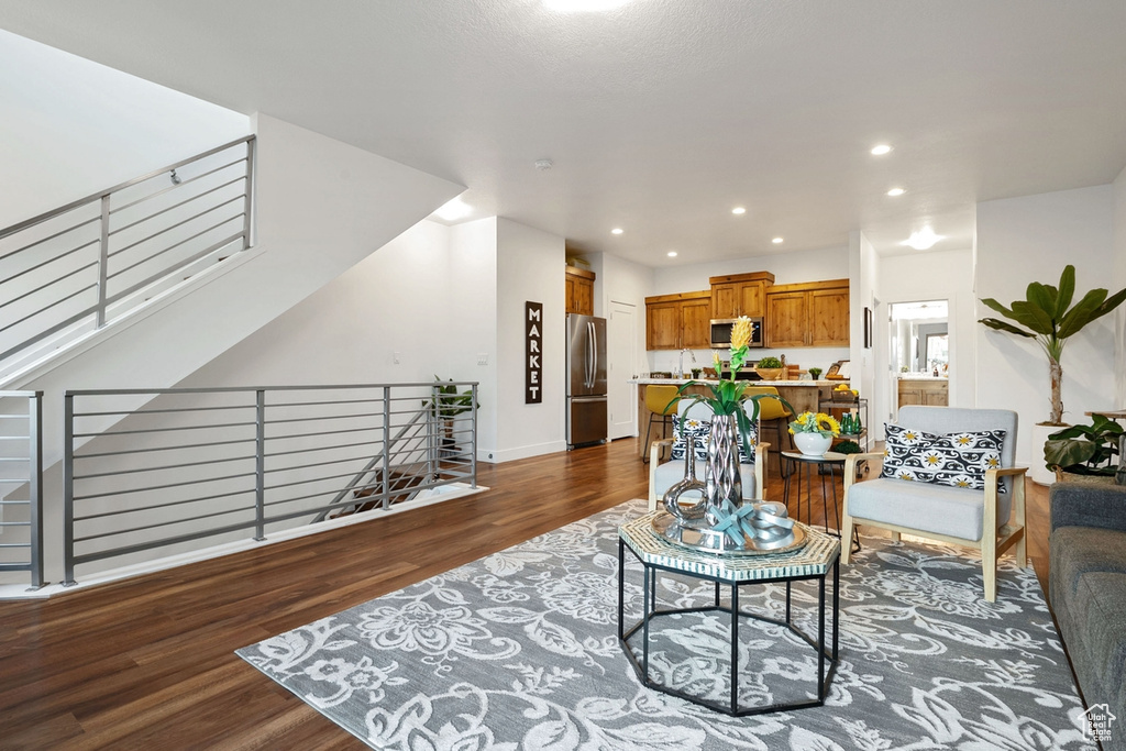 Living area featuring recessed lighting, wood finished floors, and baseboards