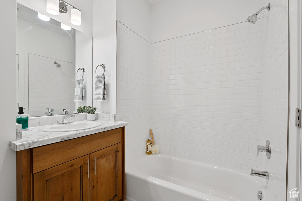 Bathroom with vanity and shower / washtub combination