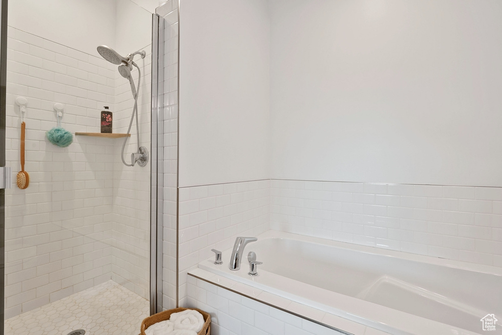 Bathroom featuring a bath and a stall shower