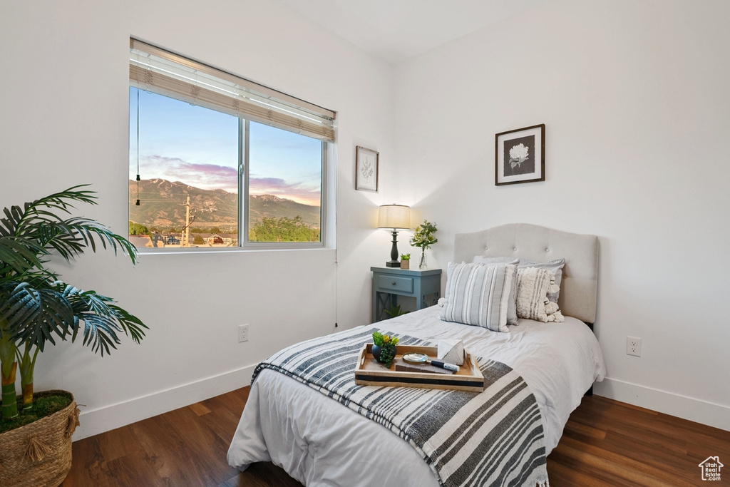 Bedroom featuring baseboards and wood finished floors
