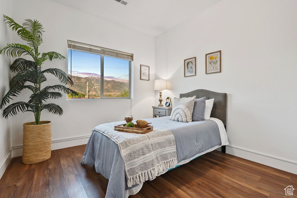 Bedroom featuring baseboards and wood finished floors