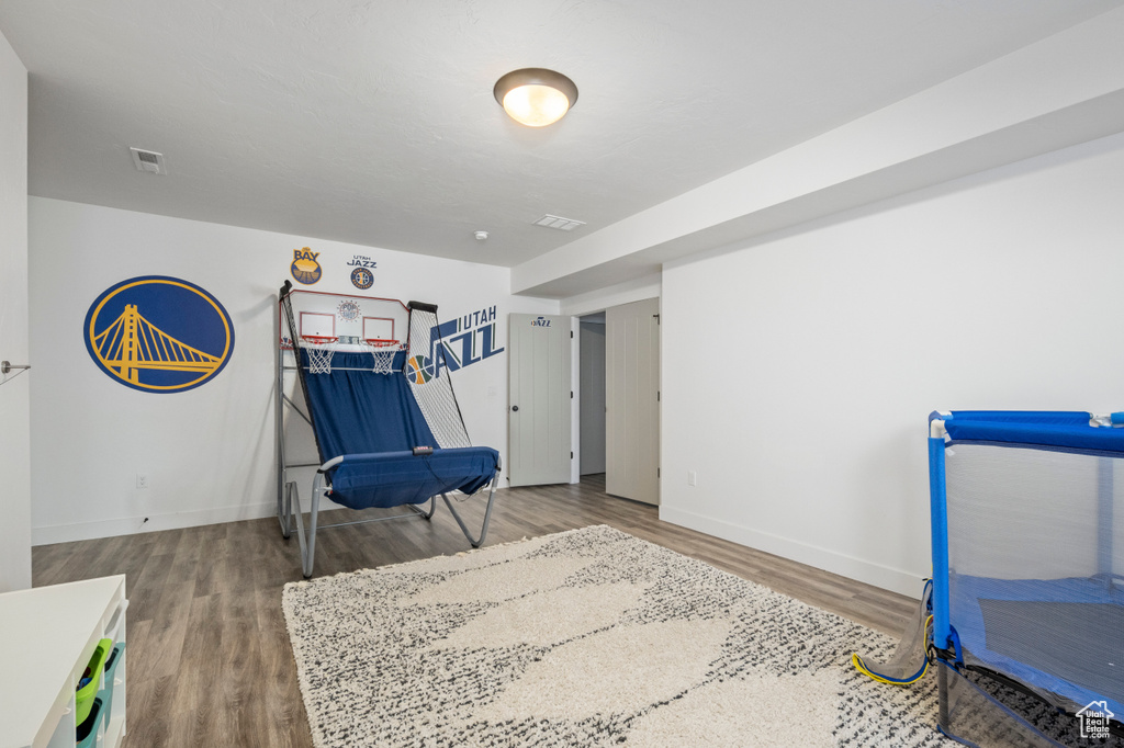 Sitting room with wood finished floors and baseboards