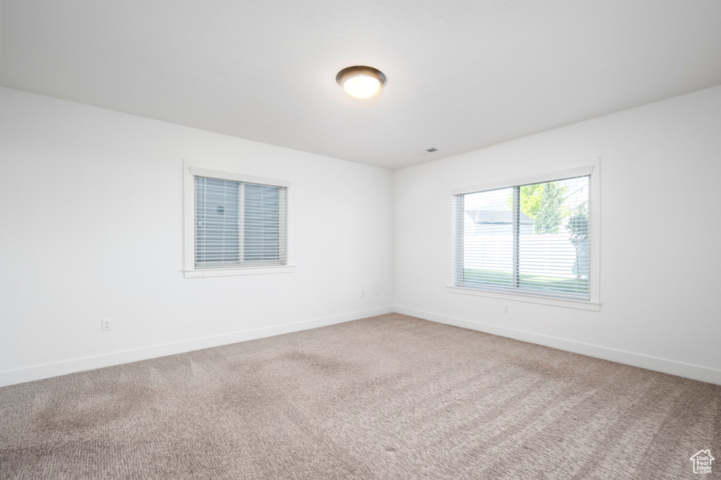 Unfurnished room featuring carpet flooring and baseboards