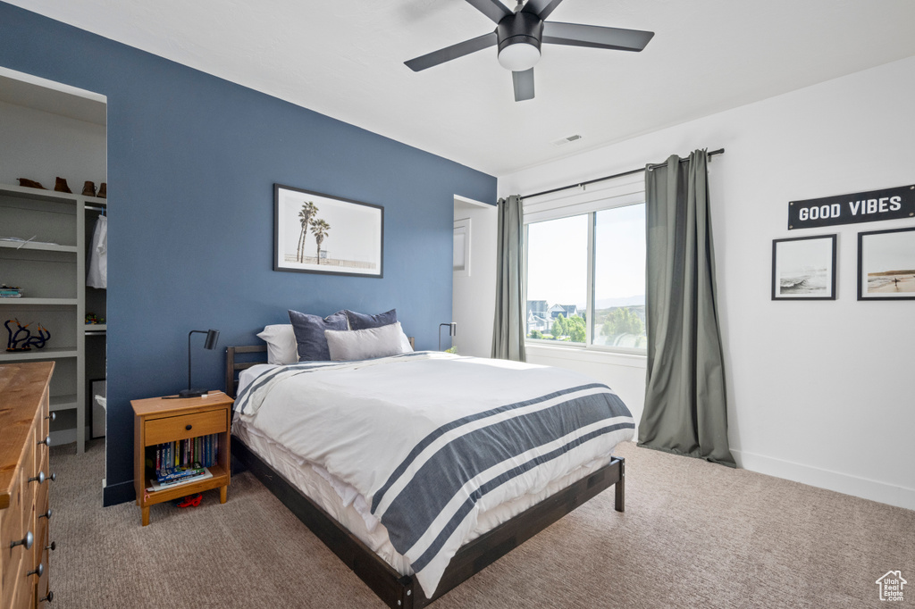 Carpeted bedroom with baseboards and ceiling fan
