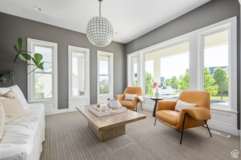 Carpeted living room featuring baseboards