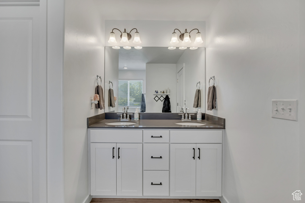 Bathroom with double vanity and baseboards