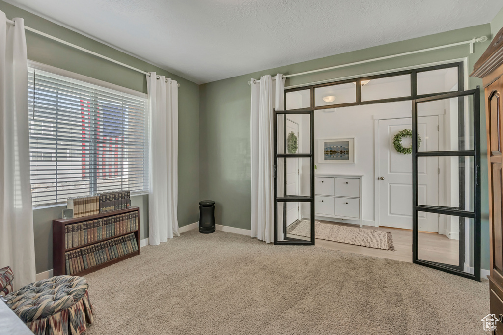 Bedroom with carpet, baseboards, and a textured ceiling