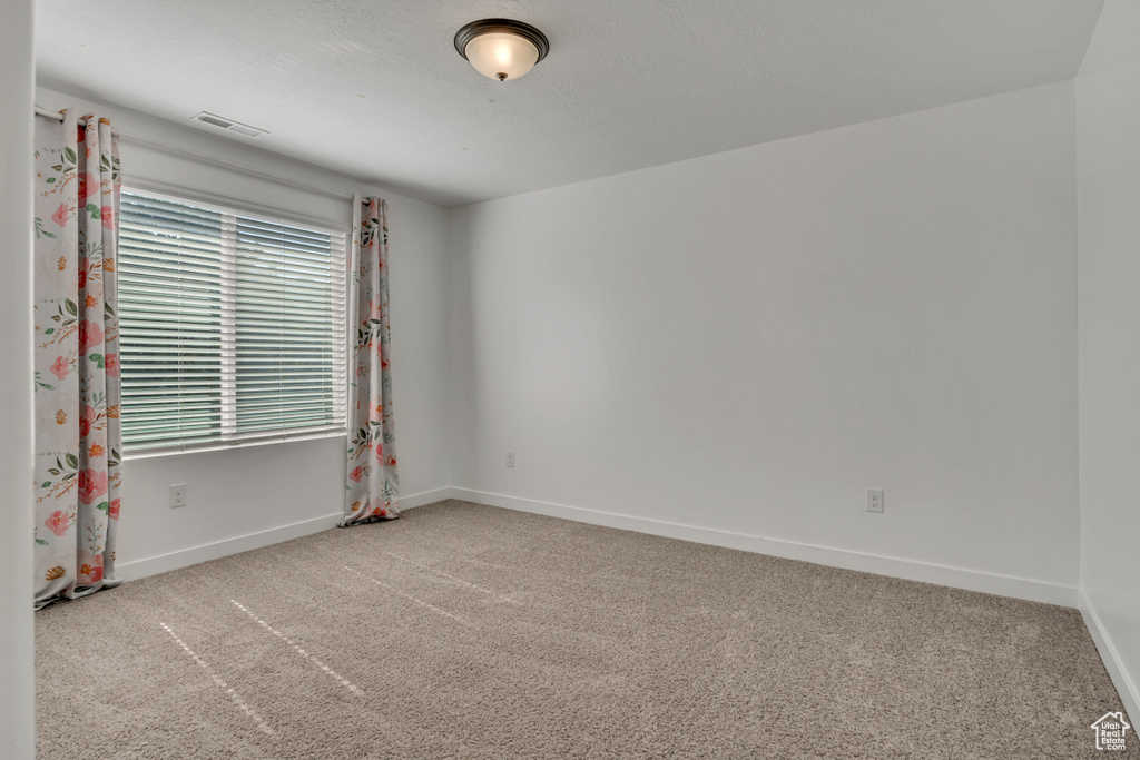 Unfurnished room with carpet flooring and baseboards
