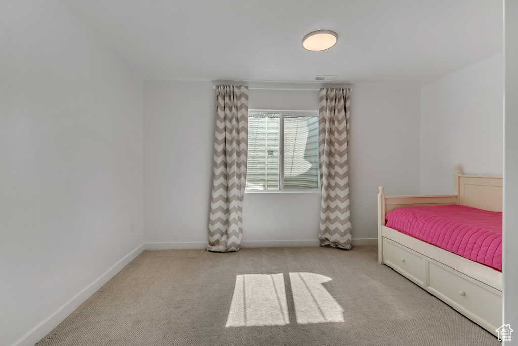 Carpeted bedroom featuring baseboards