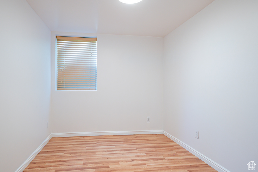 Spare room with light wood-style flooring and baseboards