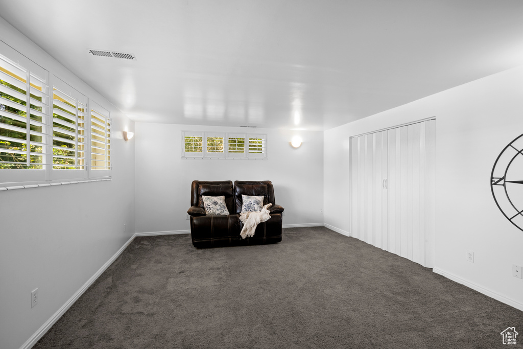 Unfurnished room with carpet, plenty of natural light, and baseboards