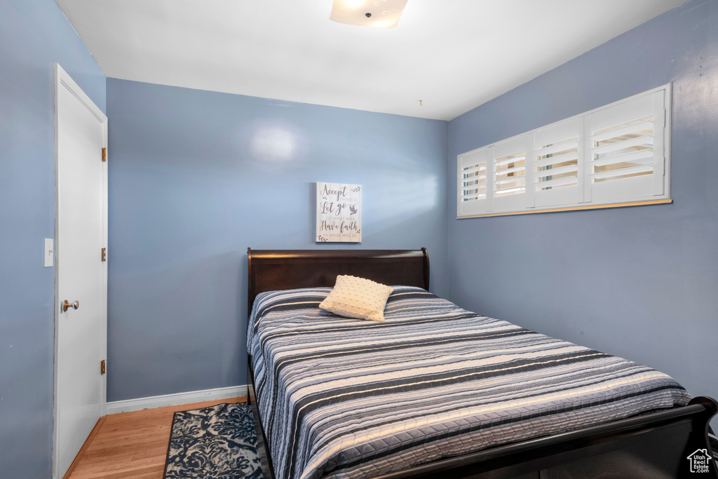 Bedroom featuring wood finished floors and baseboards