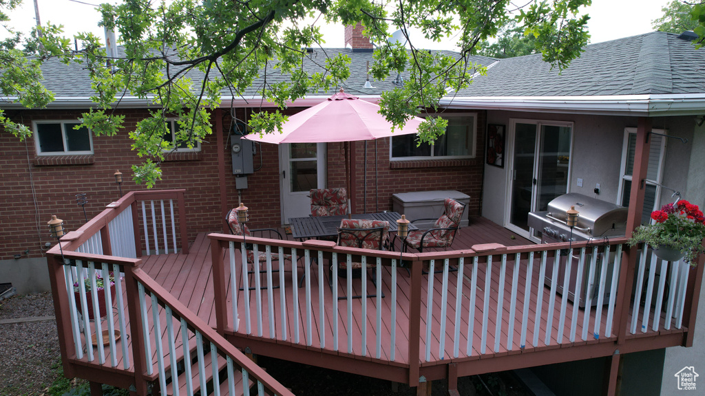 Wooden terrace featuring area for grilling