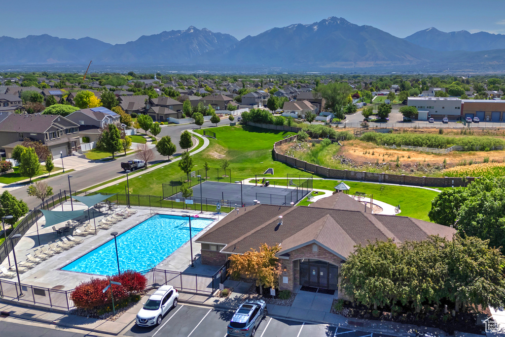 Aerial view of residential area with a mountainous background and a pool