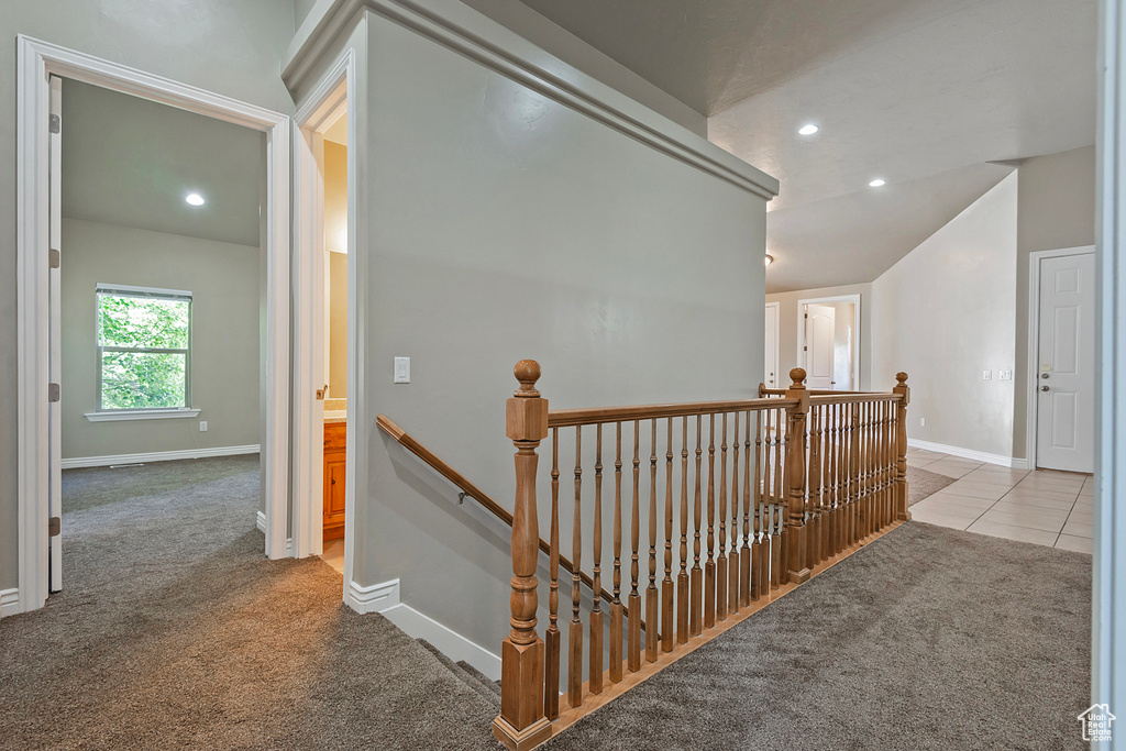 Hallway featuring an upstairs landing, carpet, baseboards, recessed lighting, and vaulted ceiling