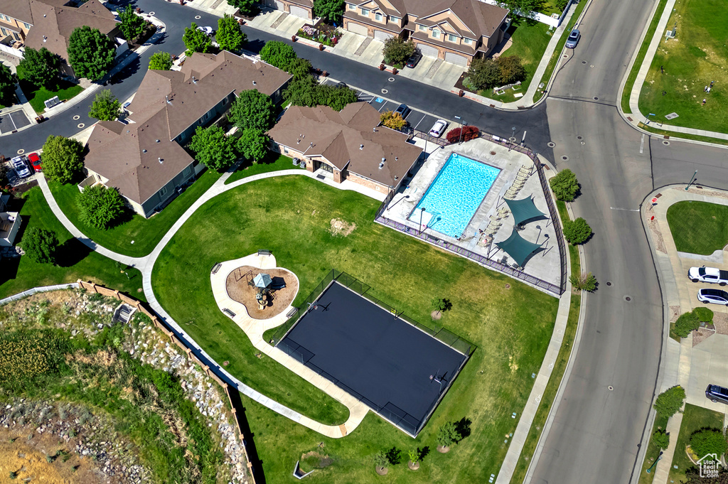 Aerial overview of property's location with a pool and nearby suburban area