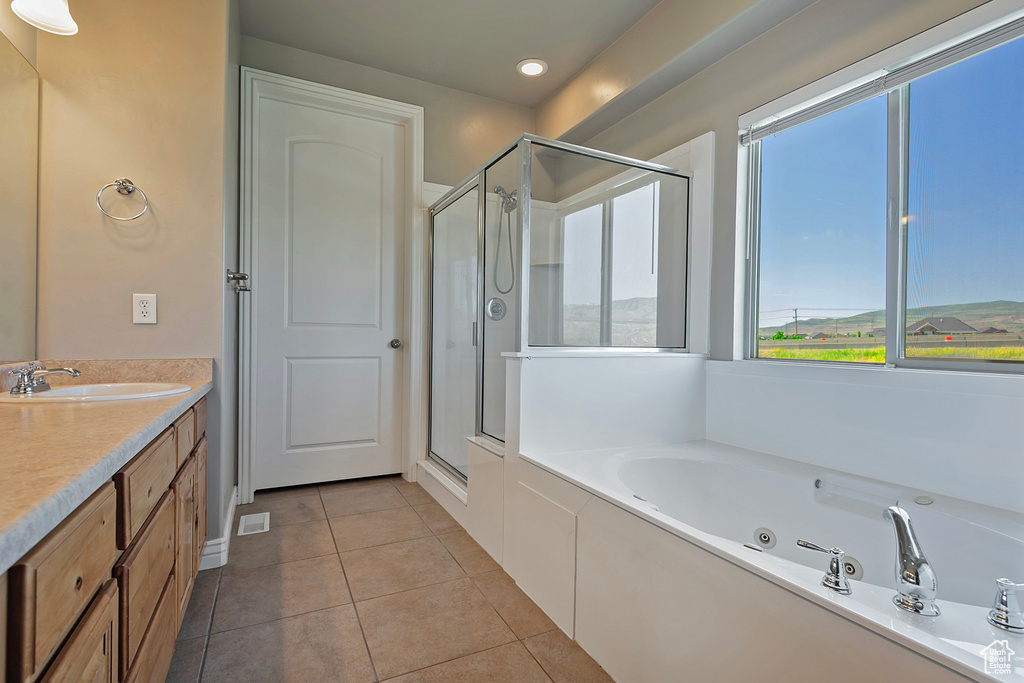 Full bathroom with healthy amount of natural light, a stall shower, a whirlpool tub, and recessed lighting