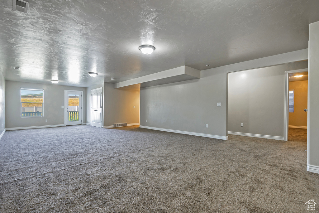 Carpeted spare room with baseboards