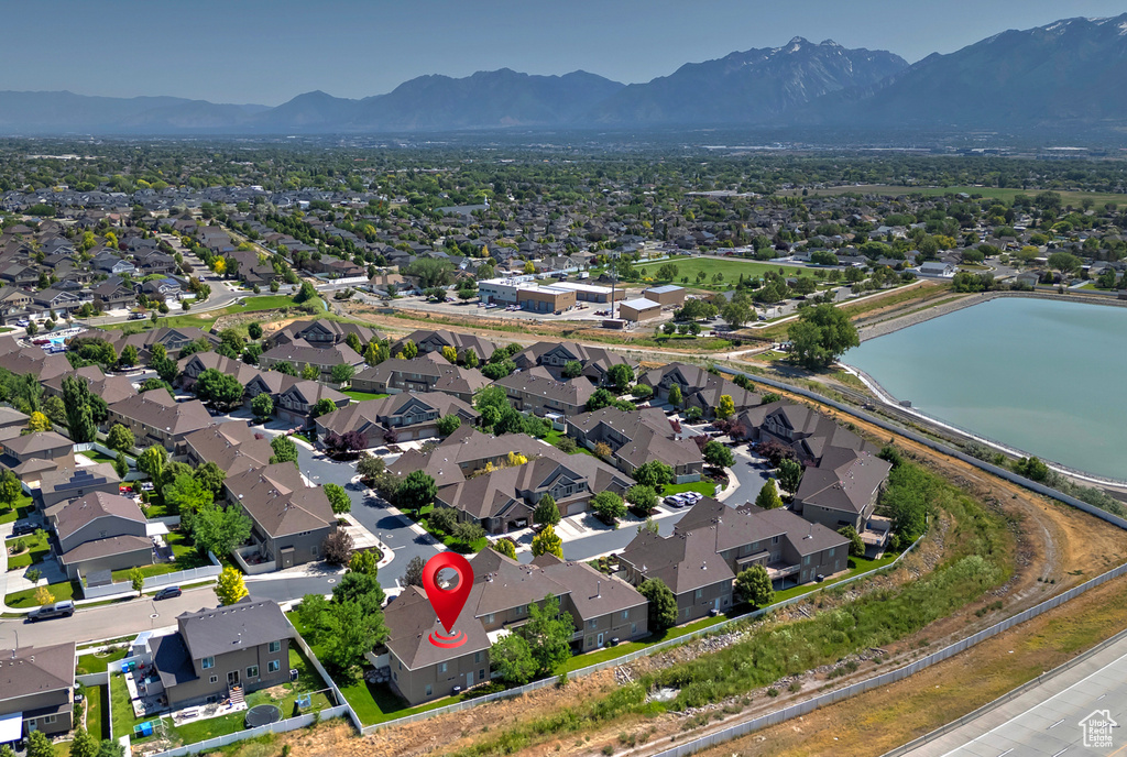 Aerial overview of property's location with nearby suburban area and a water and mountain view