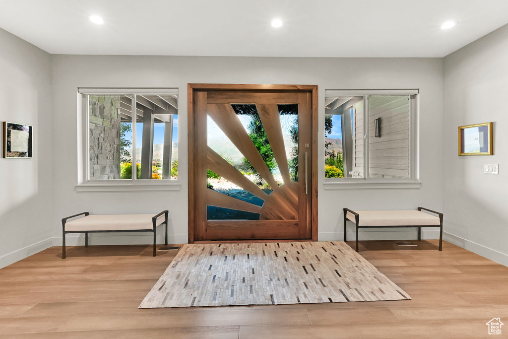 Entrance foyer featuring wood finished floors, recessed lighting, and baseboards
