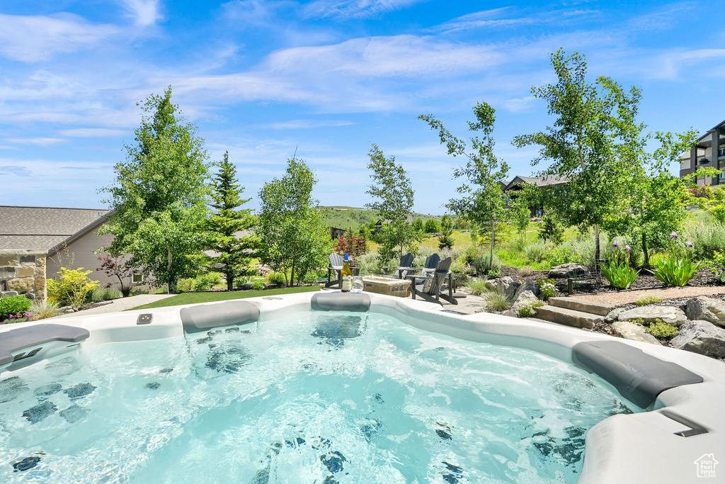 View of pool featuring an outdoor fire pit and a patio