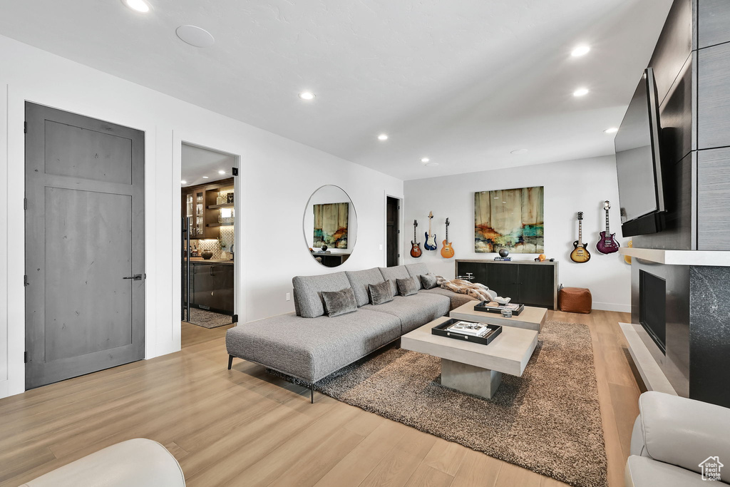 Living room featuring light wood-style flooring and recessed lighting