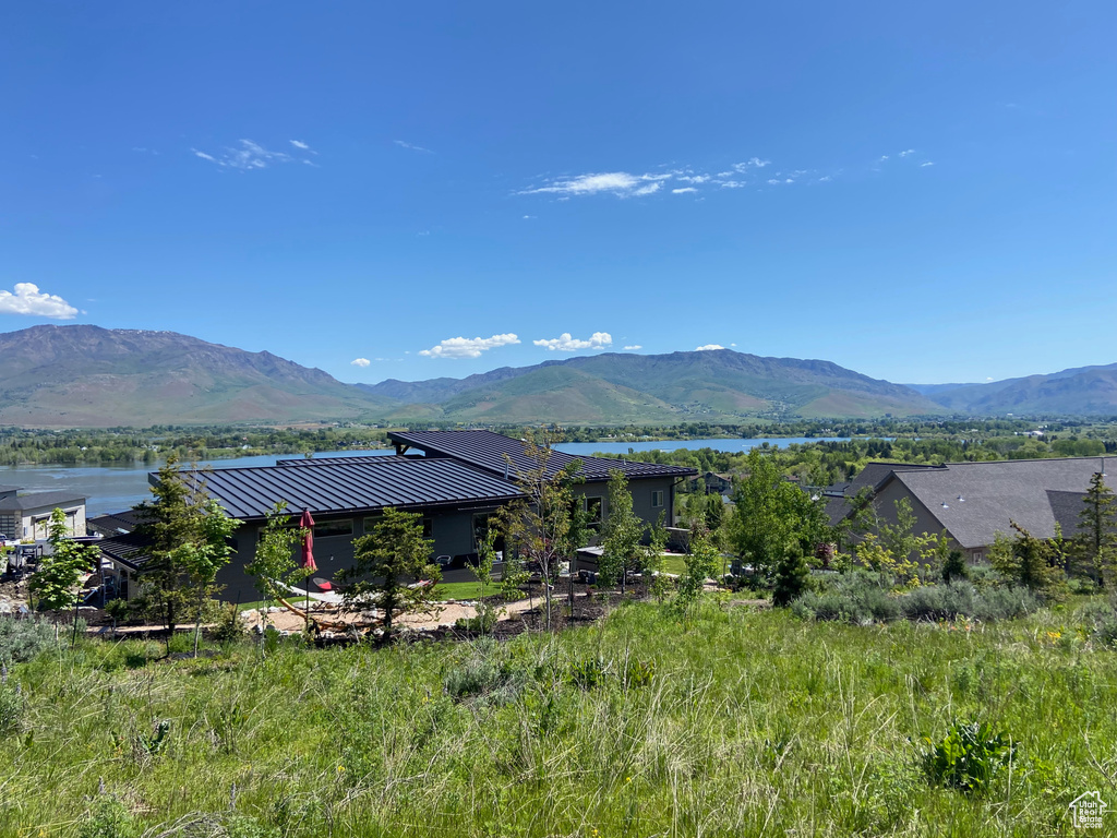 View of mountain backdrop featuring a nearby body of water