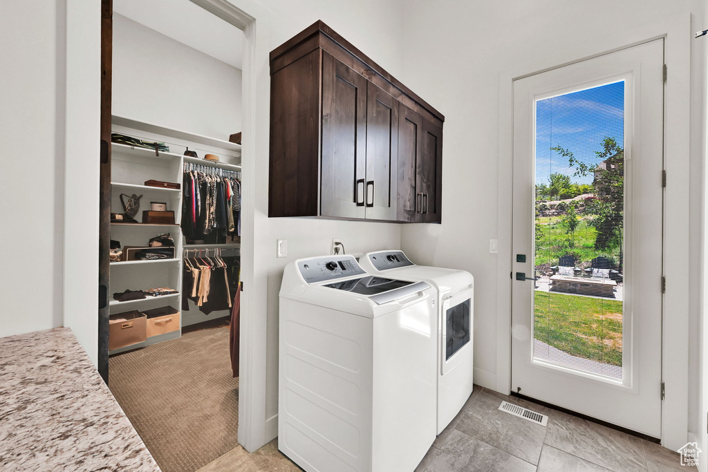 Laundry room with cabinet space and separate washer and dryer