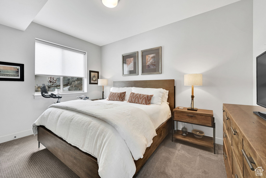 Carpeted bedroom featuring baseboards