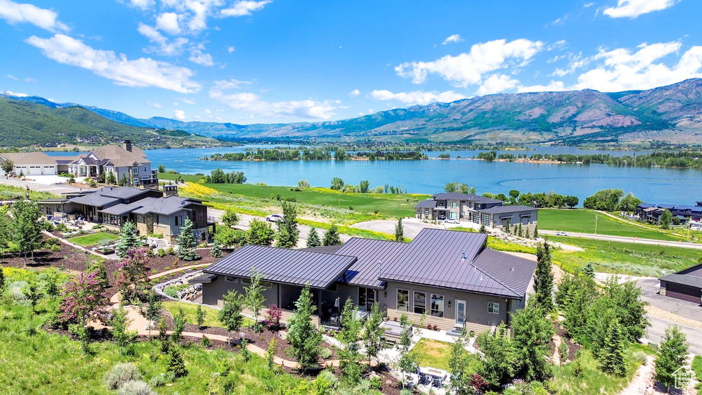 View from above of property with a water and mountain view