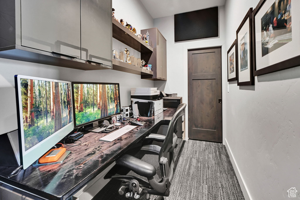 Carpeted home office with baseboards
