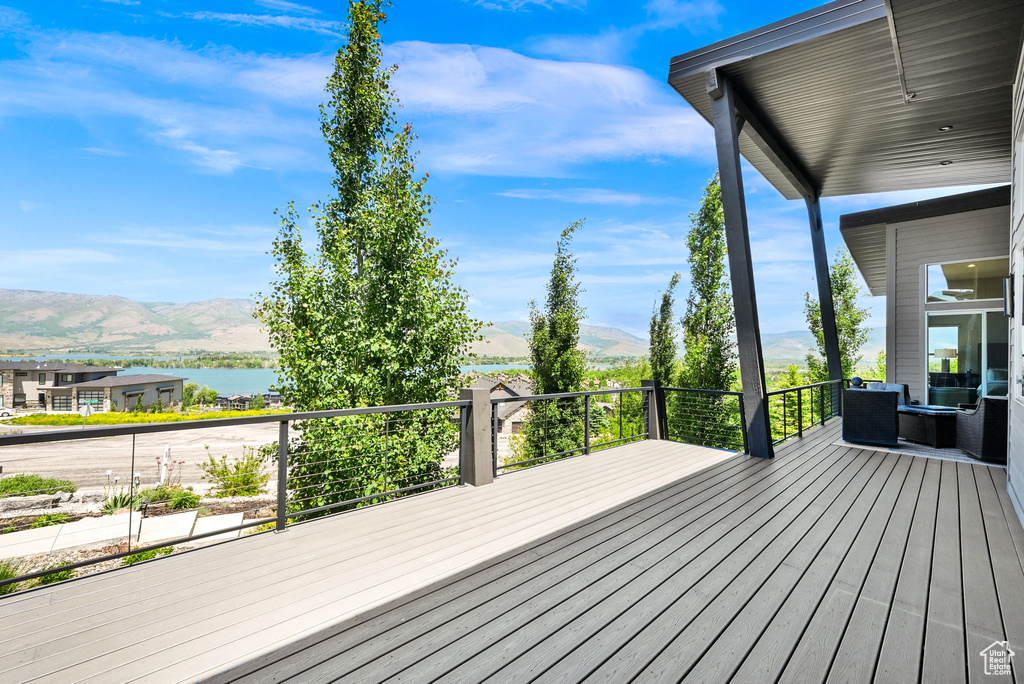 Deck with a water and mountain view