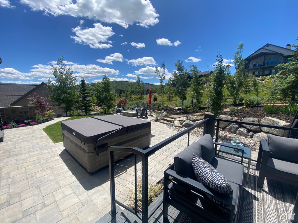 View of patio / terrace featuring outdoor lounge area and a hot tub